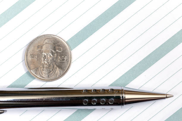 istock Notebook or diary with a pen and South Korea coin 881068502