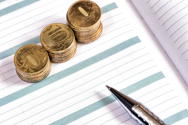 istock Notebook or diary with a pen and a rubles coin 881068562
