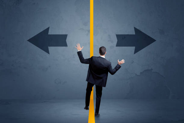 istock Business person choosing between two options separated by a yellow border arrow 881068570