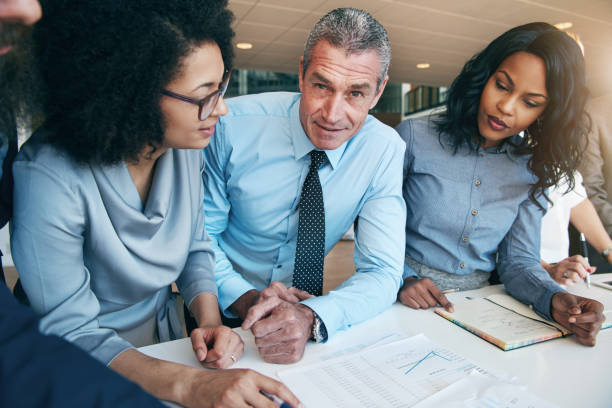 istock People planning strategy in office and looking at camera 881070620