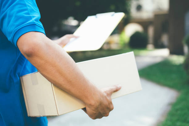 istock Delivery service courier in front of the house. 881072700