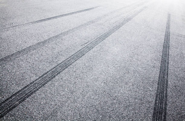 istock Wheel tracks on the road covered with hoarfrost 881072718