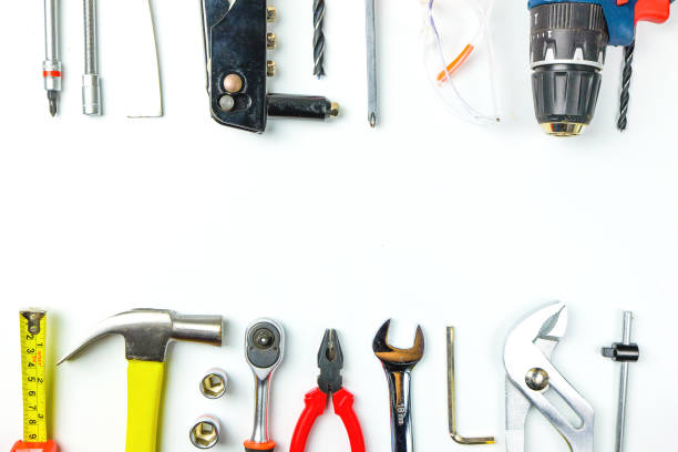 istock Top view of Working tools,wrench,socket wrench,hammer,screwdriver,plier,electric drill,tape measure,machinist square and safety glasses on white background.flat lay design. 881073692