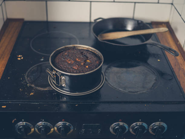 istock Burnt cake on dirty stove 881073838