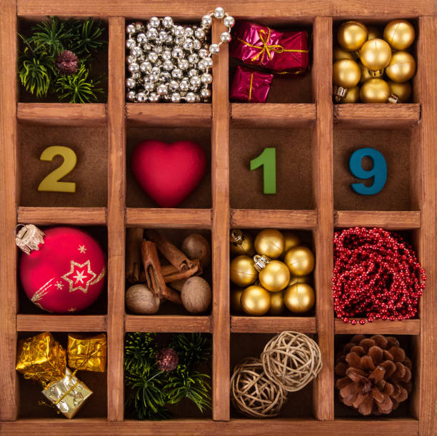 istock Set of Christmas decorations, symbol 2019, in box with cells 881083878