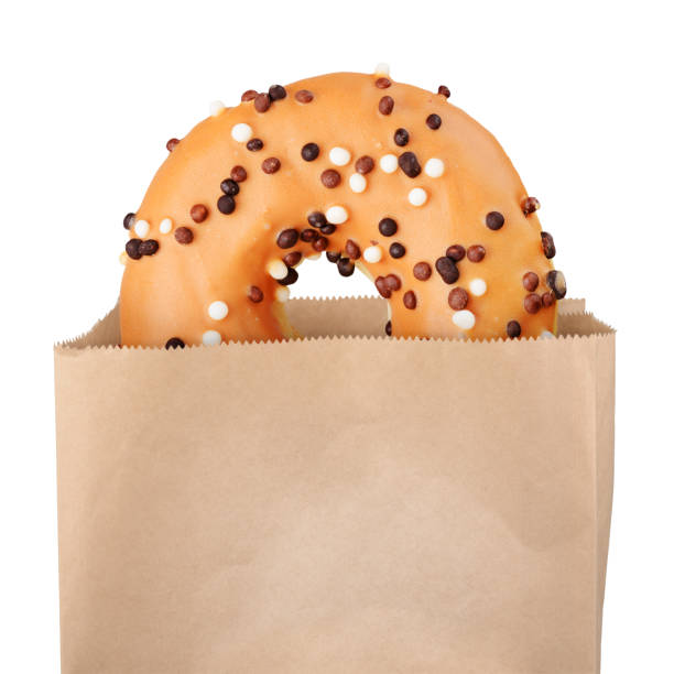 istock Yellow donut in paper bag 881084462