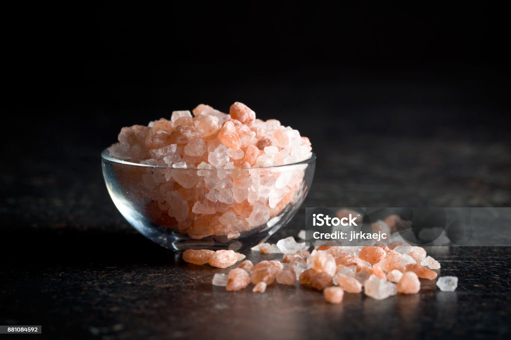himalayan salt Himalayan salt in bowl on kitchen table Rock Salt Stock Photo