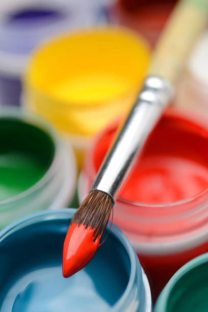 istock Gouache paint jars and paintbrush 881084742