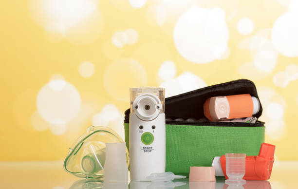 Two portable inhaler with dispenser and membrane nebulizer, on yellow background