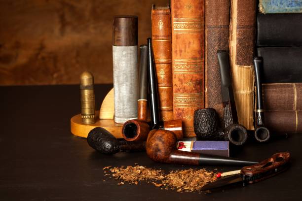 istock Tobacco and old books. Reading a detective novel. 881084772