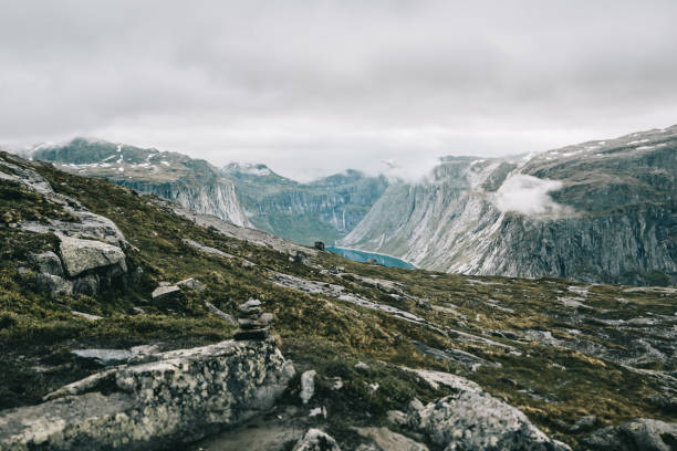 istock Heavy clouds hang over the mountains covered with snow 881089298