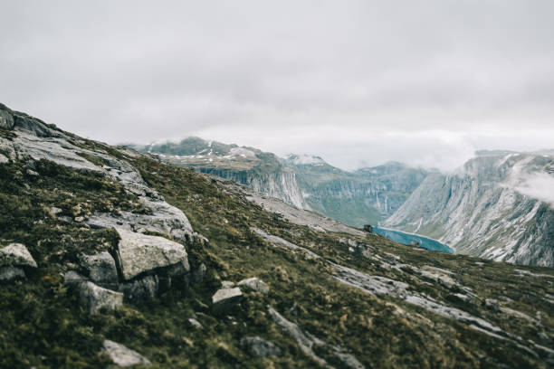 istock Heavy clouds hang over the mountains covered with snow 881089436