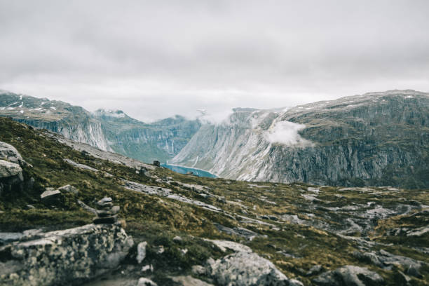 istock Heavy clouds hang over the mountains covered with snow 881089490