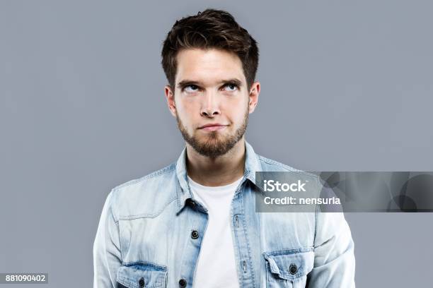 Handsome Young Man Thinking Over Gray Background Stock Photo - Download Image Now - Adult, Adults Only, Beautiful People