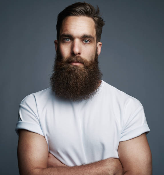 istock Bearded young man standing confidently with his arms crossed 881090476