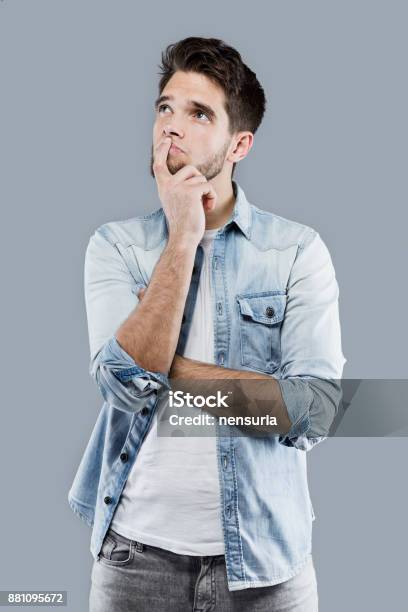 Handsome Young Man Thinking Over Gray Background Stock Photo - Download Image Now - Adult, Adults Only, Beautiful People