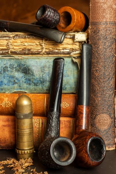 istock Tobacco and old books. Reading a detective novel. 881096008