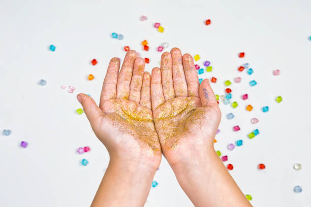 istock children's hands, hands holding beads on a white background 881096058
