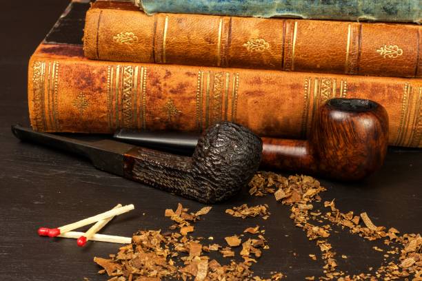istock Tobacco and old books. Reading a detective novel. 881096754