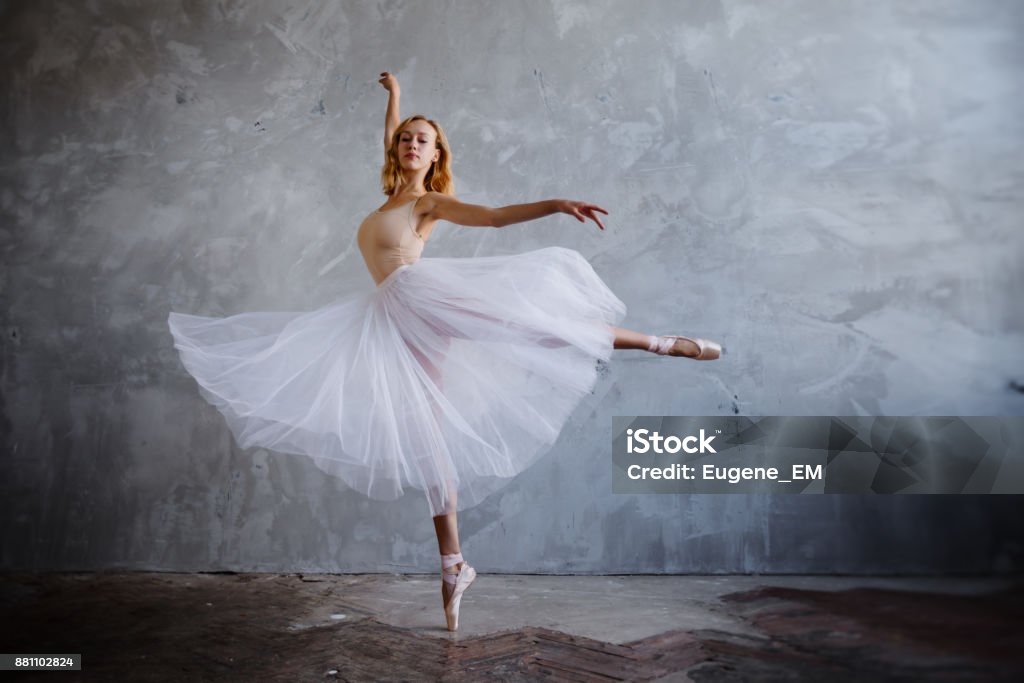 Young and slim ballet dancer is posing in a stylish studio with big windows Young and slim ballet dancer is posing in stylish studio with big windows Ballet Dancer Stock Photo