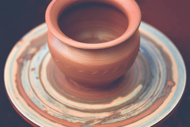 istock Potter making ceramic pot on the pottery wheel 881102826