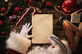 Santa Claus writting letter on wooden table