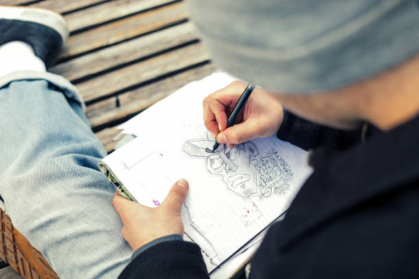 istock Young Graffiti Artist Drawing Sketches Outdoors 881108006