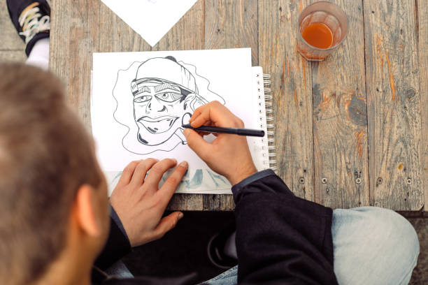 istock Young Graffiti Artist Drawing Sketches Outdoors 881108070