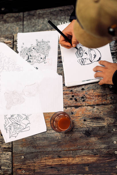 istock Young Graffiti Artist Drawing Sketches Outdoors 881108100