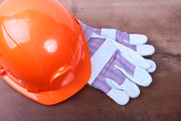 istock Orange safety engineer helmet on brown background 881111624