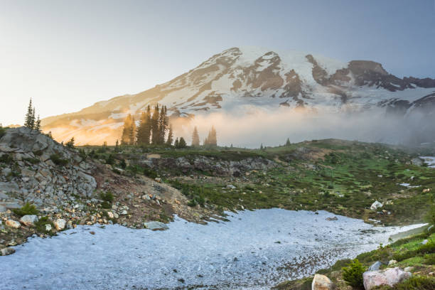istock Afternoon Sun Glows Over Fog Below Mount Rainier 881117162