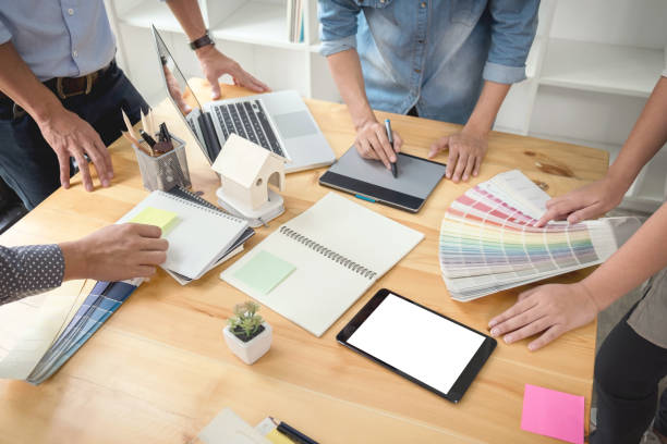 istock Young colleagues designers working together on a creative project and color samples for selection, Color swatch samples, Brainstorming Planning Partnership, creative graphic design working desktop 881118354