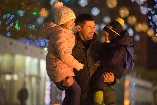 istock Father is holding his children. They are talking and smiling 881123878