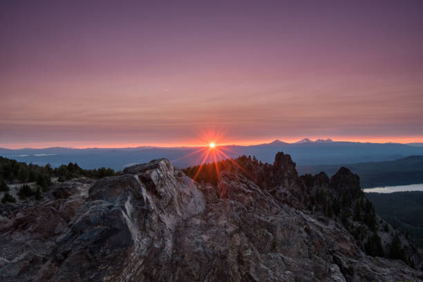 istock Clouds Light Purple Above Sunburst on Paulina Peak 881123904