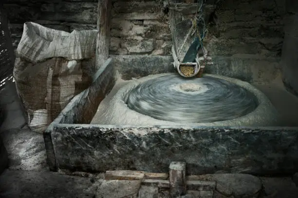 Photo of spinning milling stone of vintage water mill