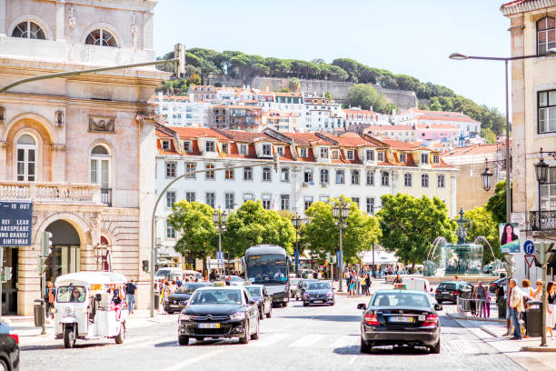 LISBON, PORTUGAL - September 27, 2017: Street view full of cars and people with beautiful buildings near the Rossio square in Lisbon city, Portugal