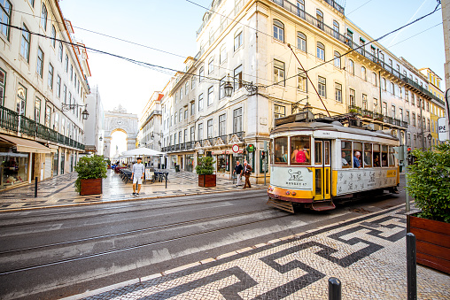LISBON, PORTUGAL - September 28, 2017: Street view with famous old tourist tram full of people during the sunny day in Lisbon city, Portugal