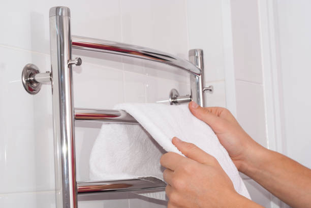 istock man hangs a towel on the dryer 881146640
