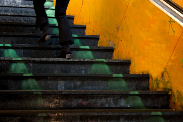 istock Legs going up city subway stairs 881150290