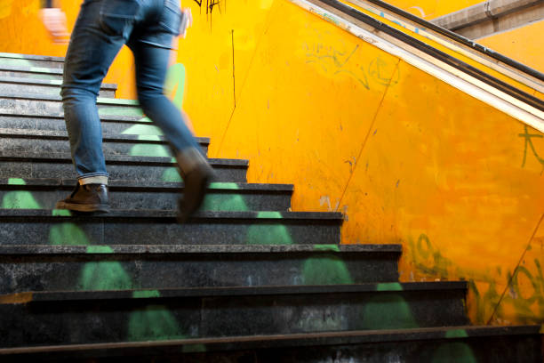 istock Legs going up city subway stairs 881152486