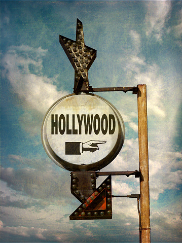 aged and worn hollywood sign with cloudy sky