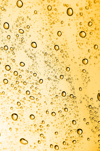istock golden water drops on glass 881154968