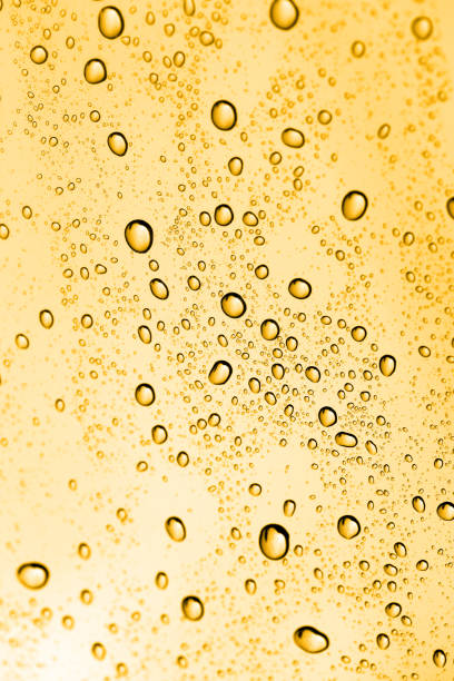 istock golden water drops on glass 881155216