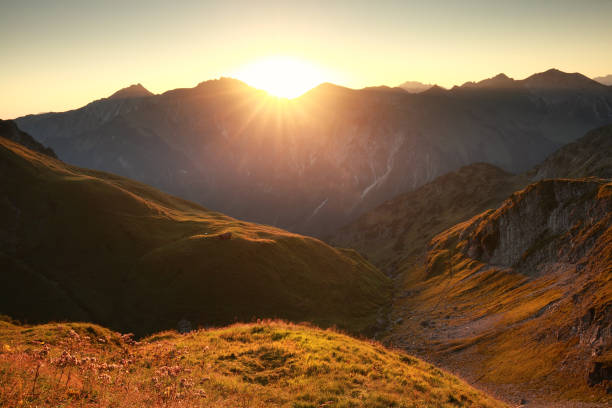 istock golden sunrise in mountains in summer 881157014