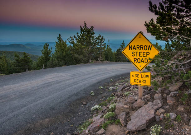 istock Narrow Steep Road Sign at Sunset 881165110