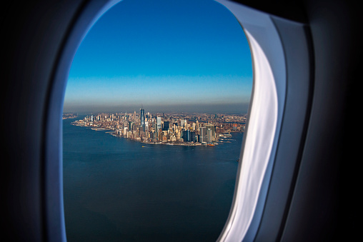 New York City skyline through the airplane's window. Horizontal composition. Image taken with Nikon D800 and developed from Raw format.