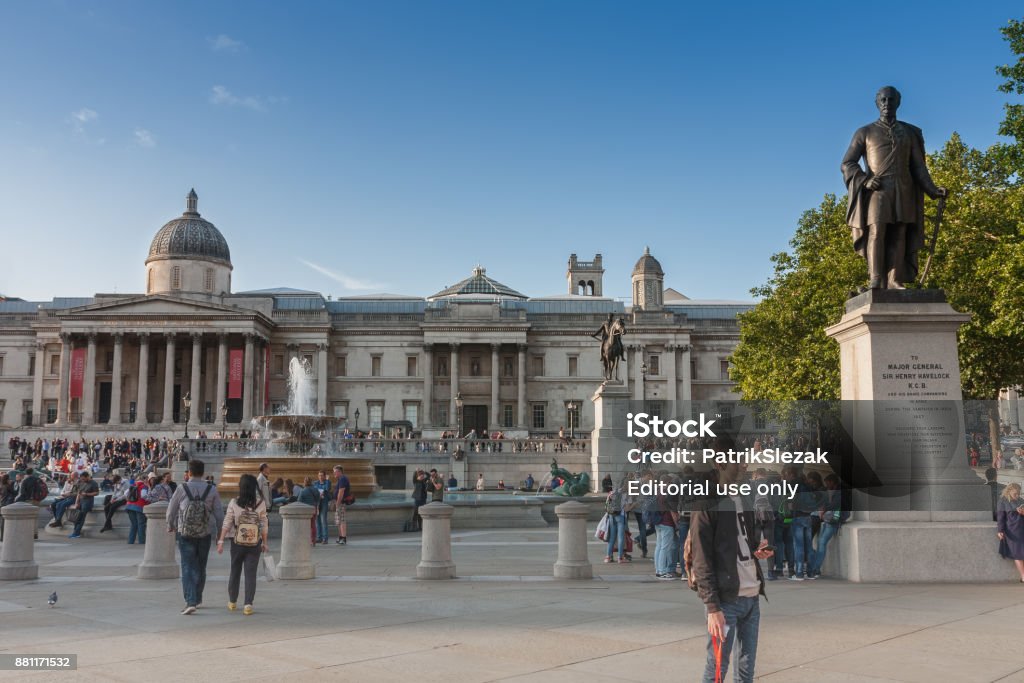 Tourists walking on Trafalgar Square Tourists walking on Trafalgar Square, on background The National Gallery on September 6, 2017 in London, United Kingdom Architectural Column Stock Photo