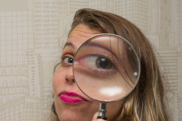 Great concept of search, woman looking through the magnifying glass