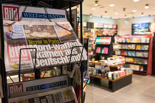 Frankfurt, Germany - November 27, 2015: A close-up of a newspaper stand outside a bookstore at the airport in Frankfurt, Germany