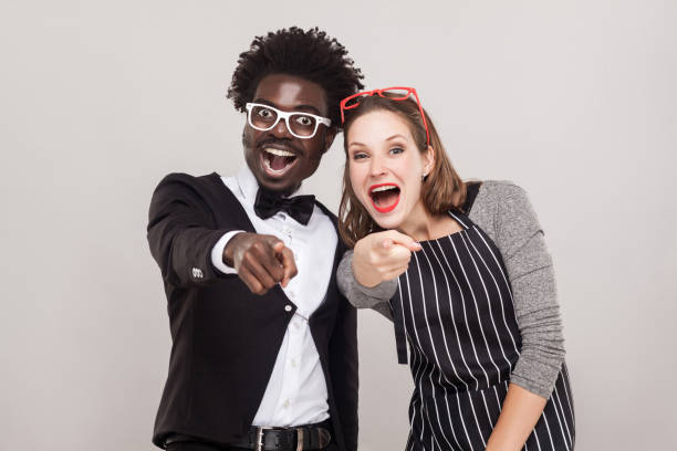 istock Mock, sneer concept. Colorful couple pointing fingers at camera 881191820